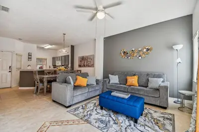a living room with two couches and a dining room at Family Stay Close to Disney Parks in Kissimmee