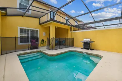 a swimming pool in the backyard of a house at Orlando Getaway w Heated Pool in Kissimmee