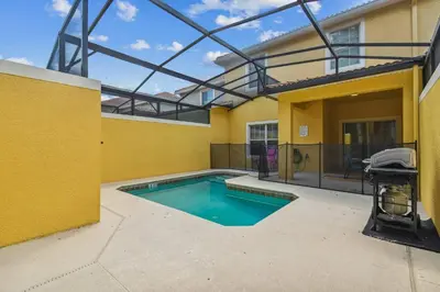 a swimming pool in the backyard of a house at Orlando Getaway w Heated Pool in Kissimmee