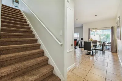 a staircase in a home with a dining room at Disney Retreat – 15min to Parks in Kissimmee