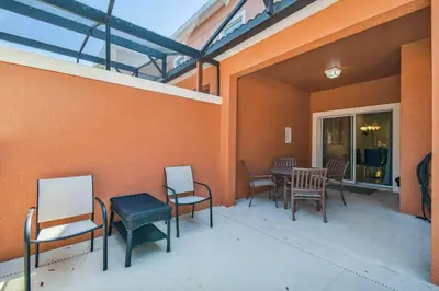 a patio with chairs and a table in a building at Disney Retreat – 15min to Parks in Kissimmee