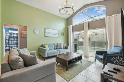 a living room with a couch and a table at Family Retreat near Disney in Kissimmee