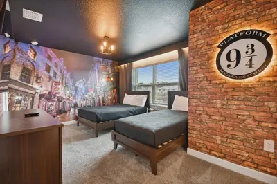 a bedroom with two beds and a brick wall at Family Retreat near Disney in Kissimmee
