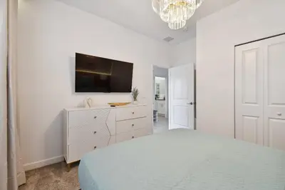 a bedroom with a bed and a tv on a wall at Family Retreat near Disney in Kissimmee