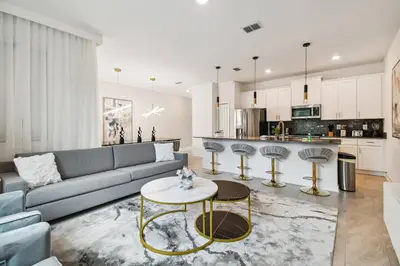 a living room with a couch and a table at 4BR Townhome Near Disney Water Park in Kissimmee