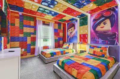 a bedroom with two beds and a colorful wall at 4BR Townhome Near Disney Water Park in Kissimmee
