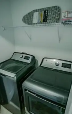 a shelf with two cell phones and a tv at Orlando Retreat – 4BR Home Near Disney in Kissimmee