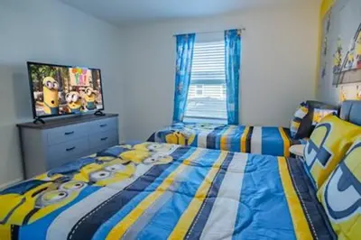 a bedroom with two beds and a tv in it at Orlando Retreat – 4BR Home Near Disney in Kissimmee