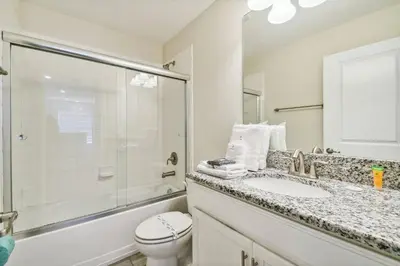 a bathroom with a sink and a shower and a toilet at Luxury Family Retreat Near Disney in Kissimmee