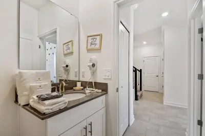 a white bathroom with a sink and a mirror at Spacious Orlando Stay near Disney in Kissimmee