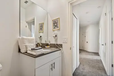 a white bathroom with a sink and a mirror at Spacious Orlando Stay near Disney in Kissimmee