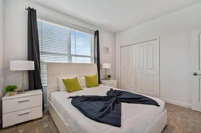 a white bedroom with a large bed and a window at Spacious Orlando Stay near Disney in Kissimmee