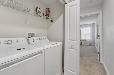 a white laundry room with a washer and dryer at Orlando Stay Near Disney with Private Pool in Kissimmee