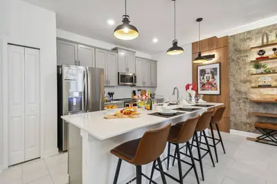 a kitchen with a large island with bar stools at Orlando Getaway – Minutes to Disney Parks in Kissimmee