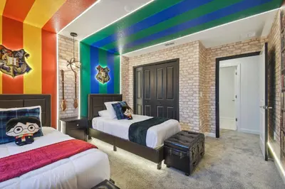 a bedroom with two beds and a rainbow wall at Orlando Getaway – Minutes to Disney Parks in Kissimmee