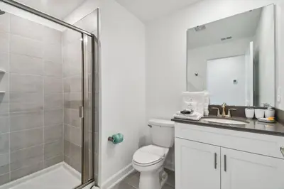 a bathroom with a shower and a toilet and a sink at Disney Getaway: Private Pool Resort in Kissimmee
