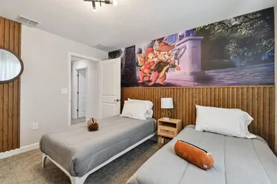 a bedroom with two beds and a painting on the wall at Disney Getaway: Private Pool Resort in Kissimmee