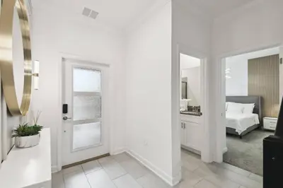a white room with a bed and a mirror at Private Pool Luxury Resort Amenities in Kissimmee