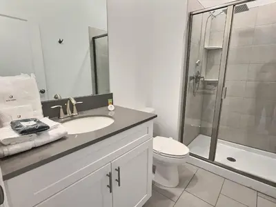 a bathroom with a sink and a toilet and a shower at Luxury Home Near Disney Orlando in Kissimmee