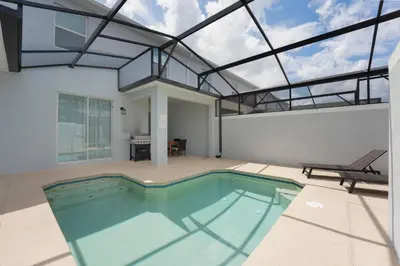 an indoor swimming pool in a house with a glass ceiling at Luxury Family Stay Near Disney in Kissimmee
