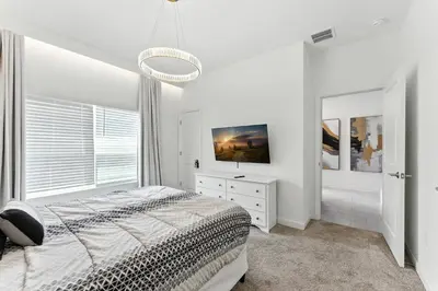 a white bedroom with a bed and a window at Luxury Family Stay Near Disney in Kissimmee