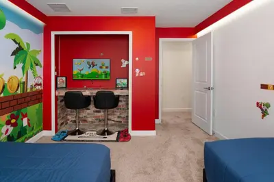 a bedroom with red walls and two chairs at Luxury Family Stay Near Disney in Kissimmee