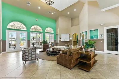 a large living room with a green wall at Family Townhome w Private Pool Orlando in Kissimmee