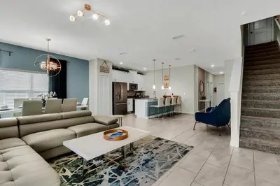 a living room with a couch and a table at Heated Pool 5-Star Amenities Near Disney in Kissimmee