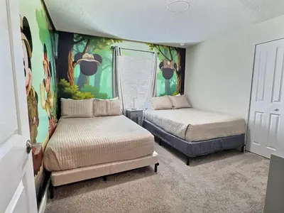 a small room with two beds and a window at Heated Pool 5-Star Amenities Near Disney in Kissimmee