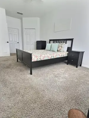 a bedroom with a large bed with a wooden frame at Family Villa near Disney – 15 Min in Kissimmee
