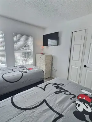 a bedroom with two beds with a mickey mouse blanket at Family Villa near Disney – 15 Min in Kissimmee