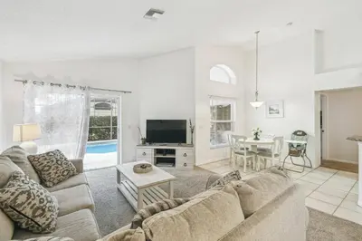a living room with a couch and a table at 4BR Home Game Room in Lake Berkley in Kissimmee