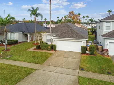 a house with a garage in a residential neighborhood at 4BR Home Game Room in Lake Berkley in Kissimmee