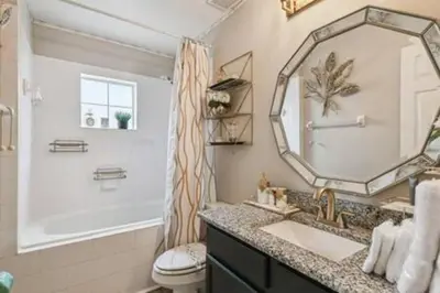 a bathroom with a sink and a mirror at Resort Townhome · Sleeps 8 · Pool in Kissimmee