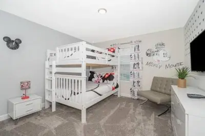 a bedroom with a white bunk bed and a desk at Family Villa · Near Disney · Sleeps 10 in Kissimmee