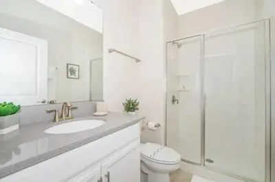 a bathroom with a sink and a toilet and a shower at Family Villa · Near Disney · Sleeps 10 in Kissimmee