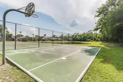 an empty tennis court with a basketball hoop at Lake Berkley · Family Home Near Disney in Kissimmee