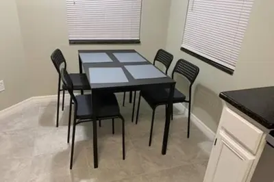 a dining room table and chairs in a kitchen at Montego Bay Retreat w Pool in Kissimmee
