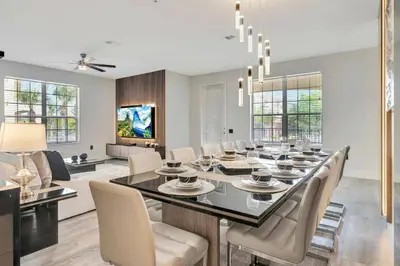 a dining room and living room with a table and chairs at Vista Cay Getaway · Orlando Stay in Orlando