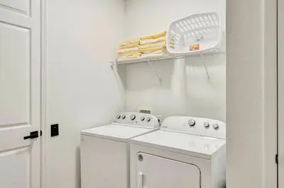 a white laundry room with a washer and dryer at Vista Cay Getaway · Orlando Stay in Orlando