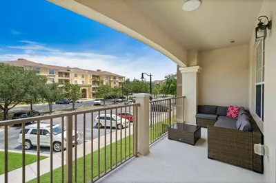a balcony with a couch and a view of a street at Vista Cay Getaway · Orlando Stay in Orlando