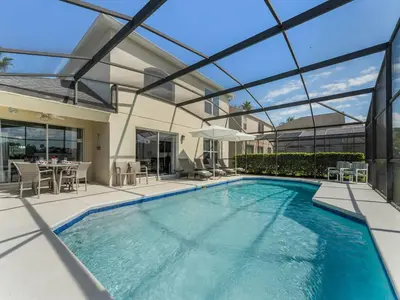 a swimming pool in a house with a glass ceiling at Spacious Home · Near Disney Parks in Kissimmee