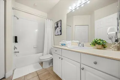 a white bathroom with a sink and a toilet at Orlando Family Stay · Pool Clubhouse in Kissimmee