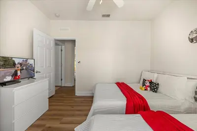 a bedroom with two beds and a flat screen tv at Orlando Family Stay · Pool Clubhouse in Kissimmee
