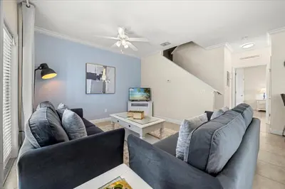 a living room with two couches and a tv at Orlando Family Stay · Pool Clubhouse in Kissimmee