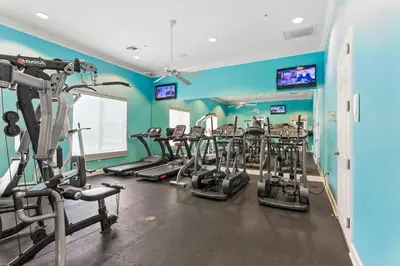 a gym with several tread machines in a room at Family Getaway wPvt Pool close to Disney in Kissimmee
