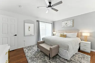 a bedroom with a bed and a ceiling fan at Two Master Suites Private Pool in Kissimmee