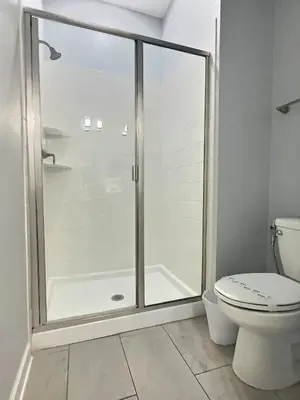 a shower stall in a bathroom with a toilet at Family Getaway near Disney Sleeps 13 in Kissimmee