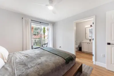 a bedroom with a bed and a large window at Family Townhouse 10 Min to Parks with Themed Room in Kissimmee