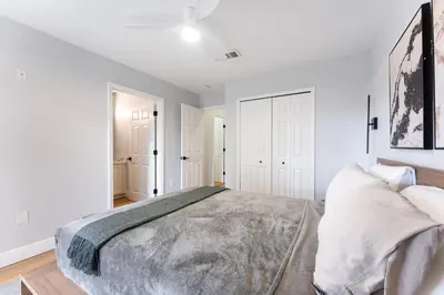 a bedroom with a large bed and white walls at Family Townhouse 10 Min to Parks with Themed Room in Kissimmee